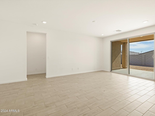 unfurnished room with light hardwood / wood-style flooring