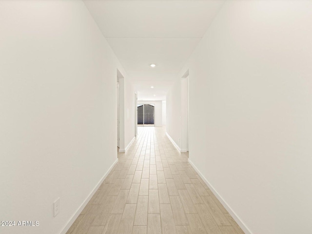 hall with light hardwood / wood-style flooring