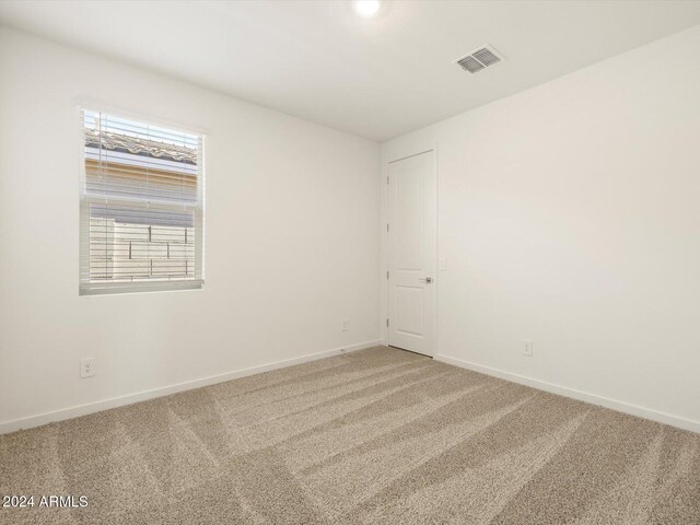 unfurnished room featuring carpet flooring