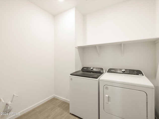 clothes washing area featuring light wood-type flooring and independent washer and dryer