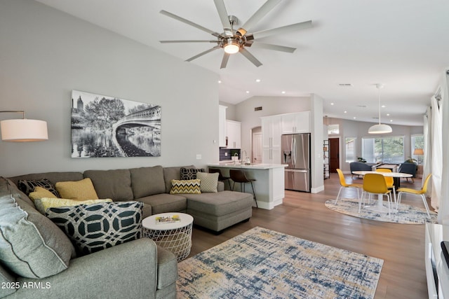 1057 W Laurel Ave, Gilbert, AZ 85233 - living room featuring lofted ceiling, a ceiling fan, wood finished floors, and recessed lighting