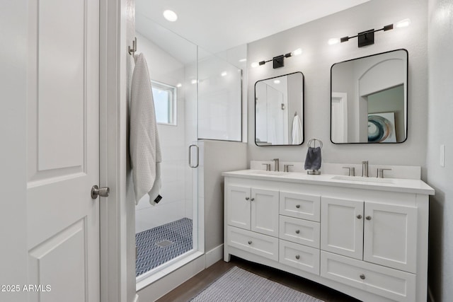 1057 W Laurel Ave, Gilbert, AZ 85233 - bathroom featuring double vanity, a stall shower, and wood finished floors