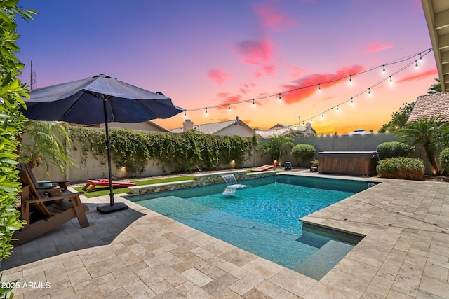 1057 W Laurel Ave, Gilbert, AZ 85233 - pool at dusk with a hot tub, a patio area, and a fenced backyard