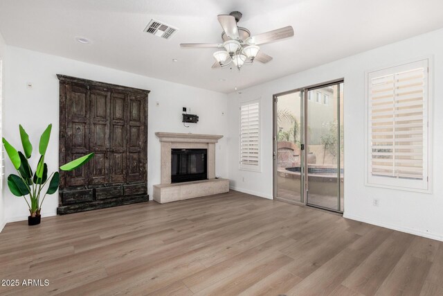 dining area with ceiling fan and a fireplace