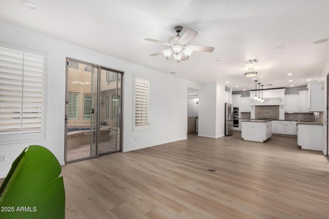 tiled living room with ceiling fan