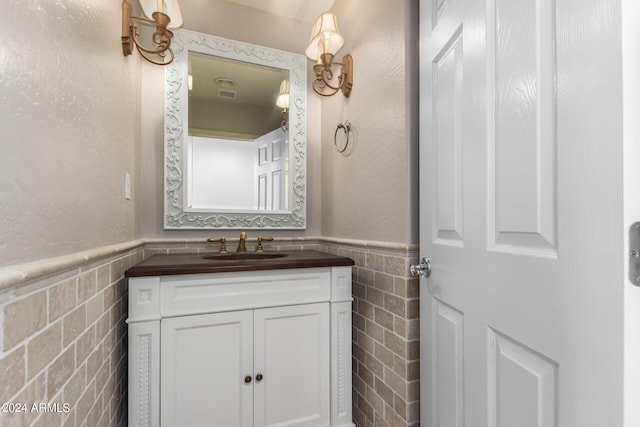 bathroom with tile walls and vanity