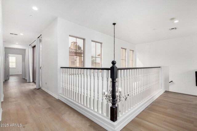 unfurnished living room featuring ceiling fan, light wood-type flooring, and a tiled fireplace