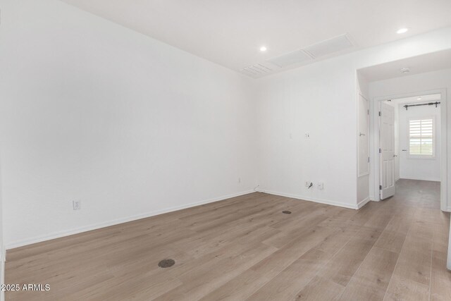 unfurnished living room with wood-type flooring and a tiled fireplace