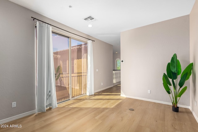 unfurnished room with wood-type flooring