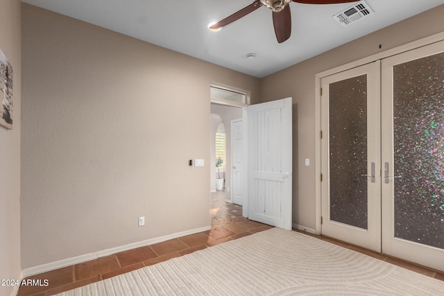 unfurnished bedroom featuring tile patterned flooring and ceiling fan