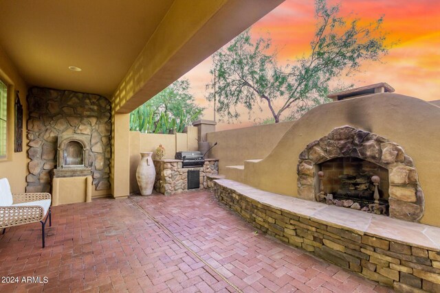 pool at dusk with a patio and an in ground hot tub