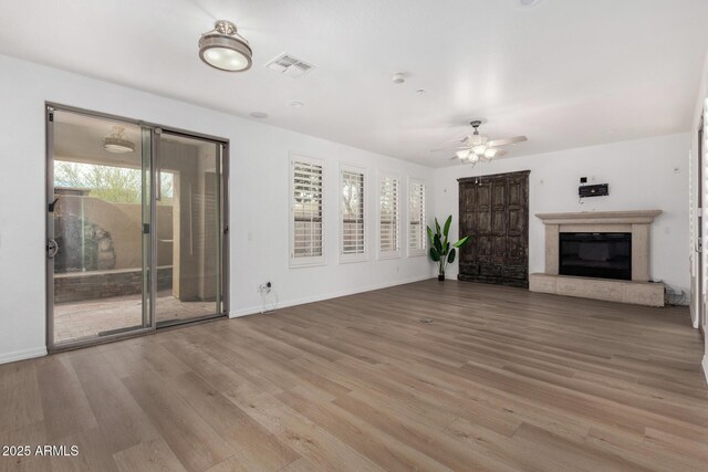 dining room with ceiling fan and a tile fireplace