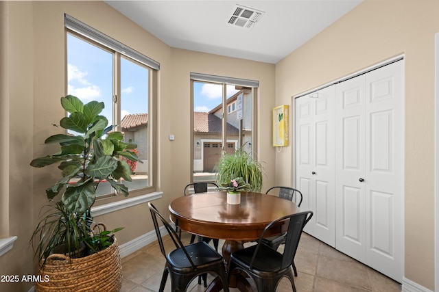 dining room with baseboards, visible vents, and light tile patterned floors