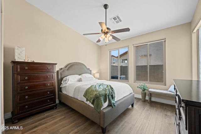 bedroom featuring baseboards, ceiling fan, visible vents, and dark wood finished floors