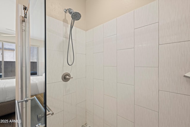 ensuite bathroom featuring ensuite bathroom and tiled shower