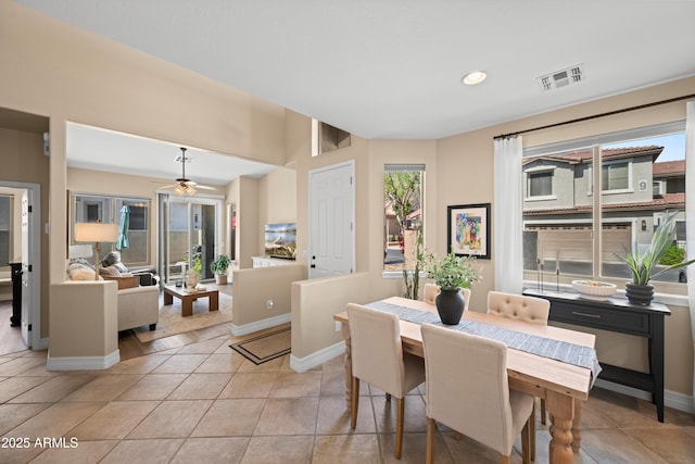 dining room with light tile patterned flooring, baseboards, visible vents, and ceiling fan