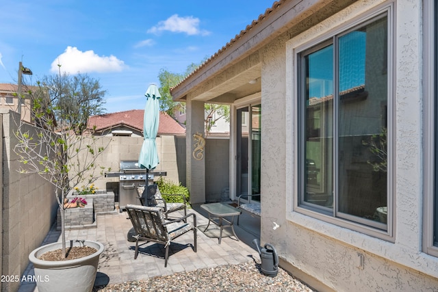 view of patio with a fenced backyard and area for grilling
