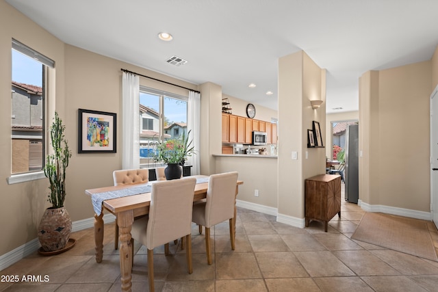 dining area featuring recessed lighting, baseboards, light tile patterned flooring, and visible vents