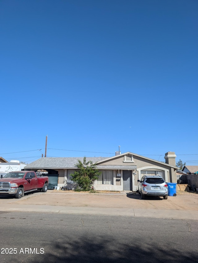 4744 W Holly St, Phoenix, AZ 85035 - view of front of property with a garage, driveway, and stucco siding