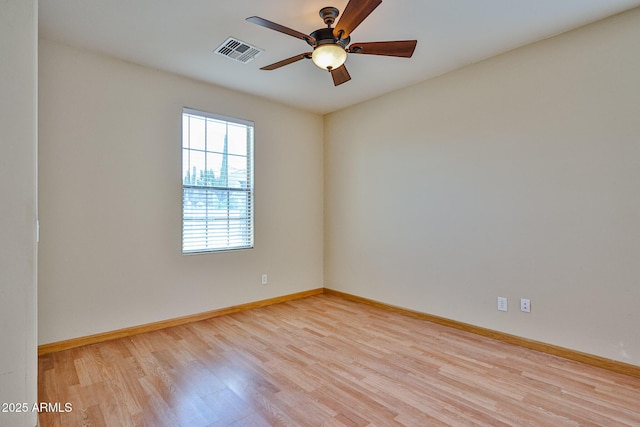 spare room with visible vents, ceiling fan, baseboards, and light wood-style floors
