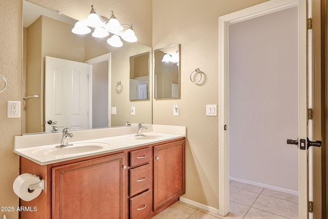 bathroom featuring tile patterned floors, double vanity, and a sink