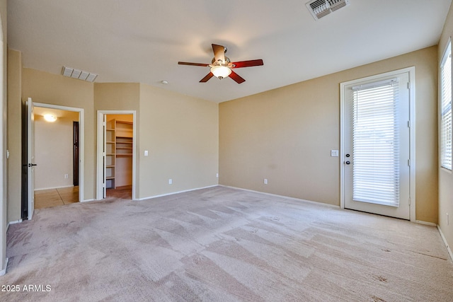 unfurnished bedroom with visible vents, ceiling fan, carpet, and baseboards