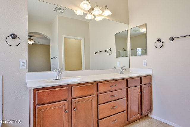 full bathroom with double vanity, a sink, ceiling fan, and visible vents