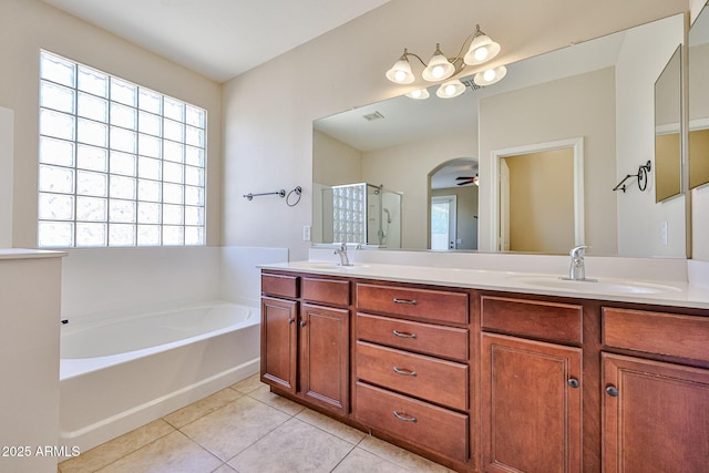 full bathroom featuring a sink, a stall shower, a bath, tile patterned floors, and a ceiling fan
