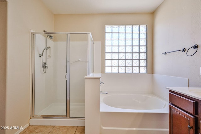 bathroom with a stall shower, a wealth of natural light, tile patterned flooring, and a bath