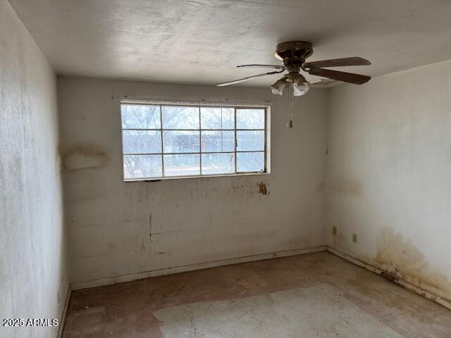 unfurnished room with ceiling fan