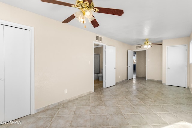 tiled empty room featuring ceiling fan