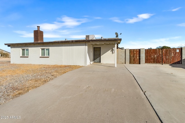 back of property featuring central AC