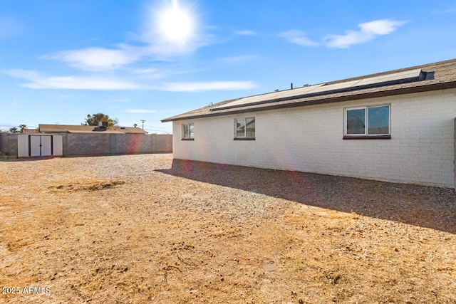 view of home's exterior with a storage shed