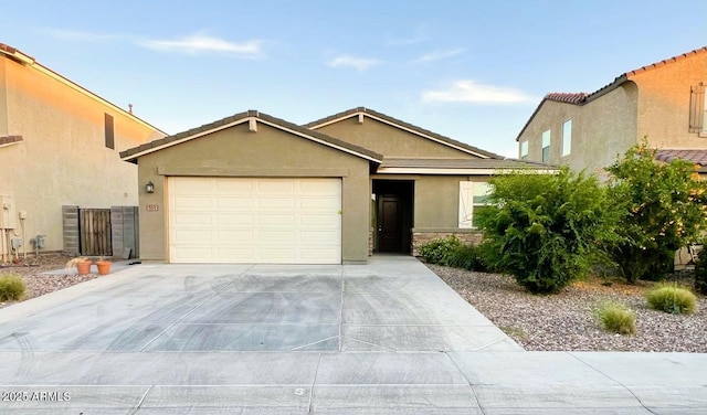 view of front of house featuring a tile roof, stucco siding, concrete driveway, and a garage