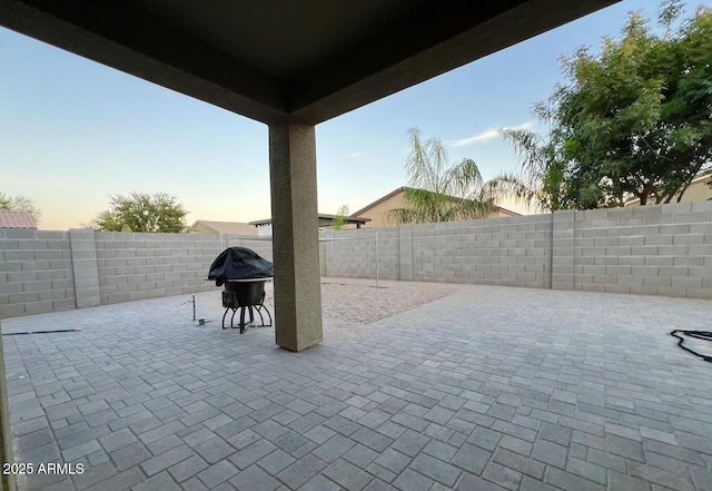 view of patio with a grill and a fenced backyard