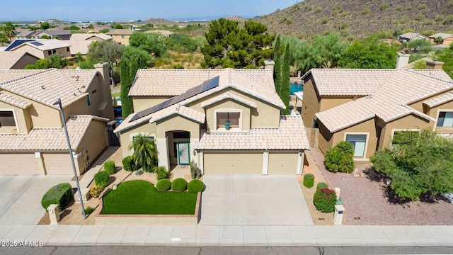 mediterranean / spanish-style house with a garage