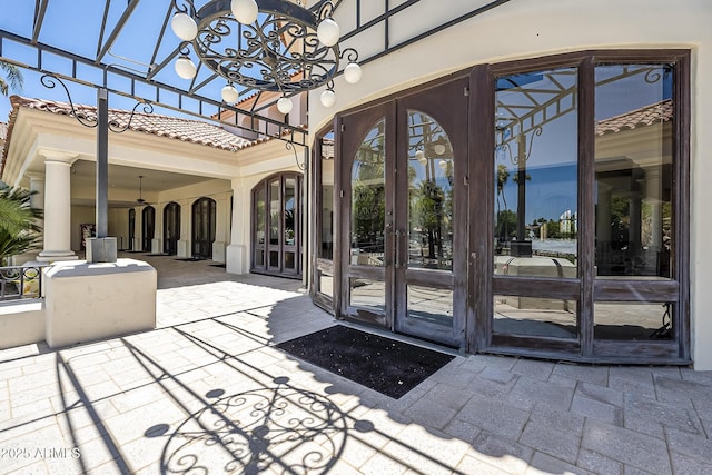 entrance to property featuring french doors and a patio