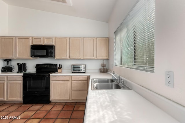 kitchen with lofted ceiling, sink, light brown cabinets, and black appliances