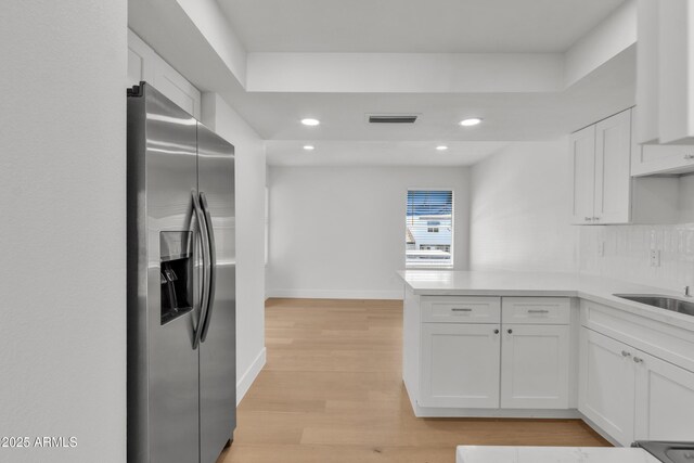 220 N 22nd Pl Unit 2036, Mesa, AZ 85213 - kitchen with stainless steel fridge with ice dispenser, a peninsula, white cabinetry, recessed lighting, and light wood finished floors