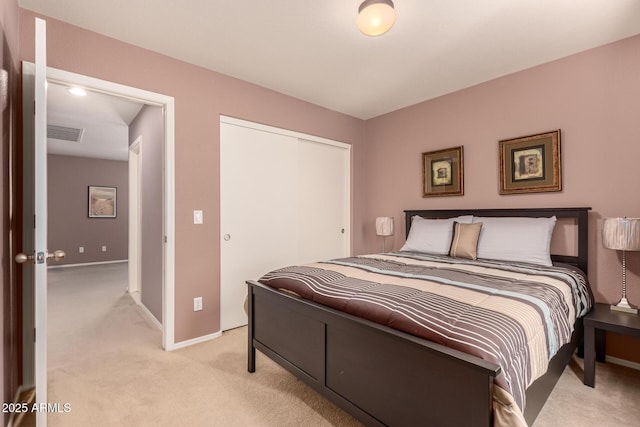 bedroom with a closet and light colored carpet