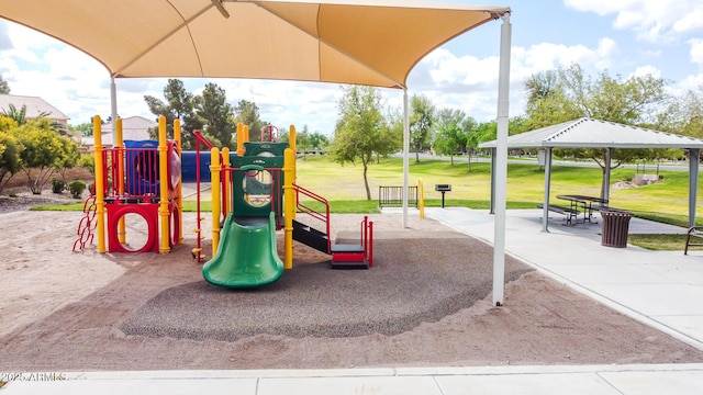 view of playground featuring a lawn and a gazebo