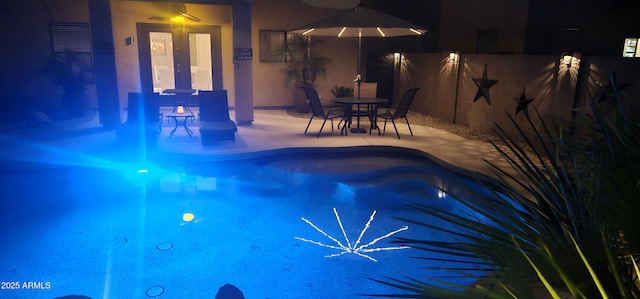 view of pool with ceiling fan and a patio