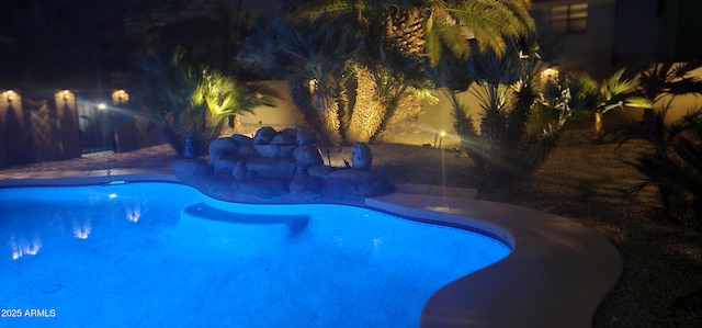 view of pool at twilight