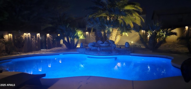 view of pool at night