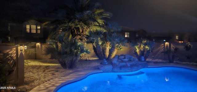 view of pool at night