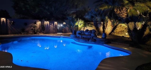 view of pool at night