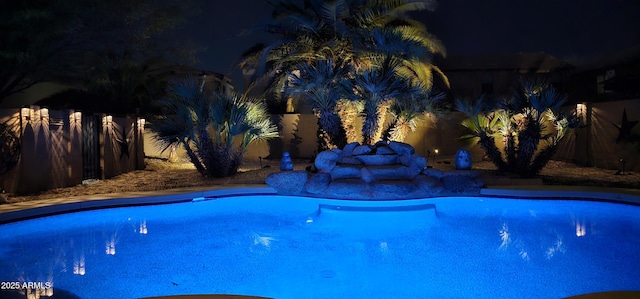 view of pool at night