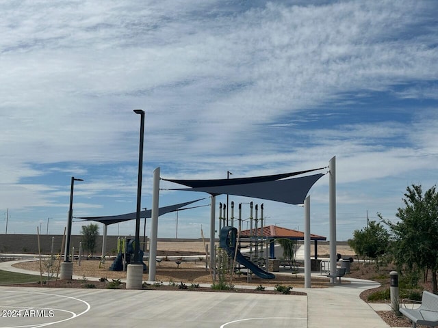 view of home's community with a playground and basketball hoop