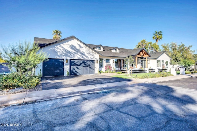 view of front facade with a garage and decorative driveway