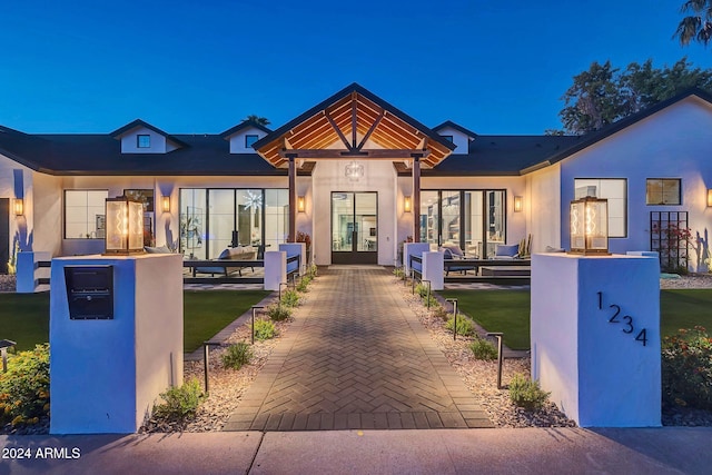 view of front of home featuring a patio area, outdoor lounge area, and stucco siding